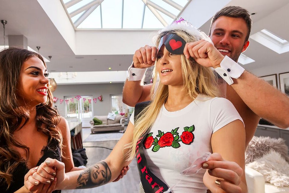 Blindfolded hen with a butler Hen party game of blindfolding bride