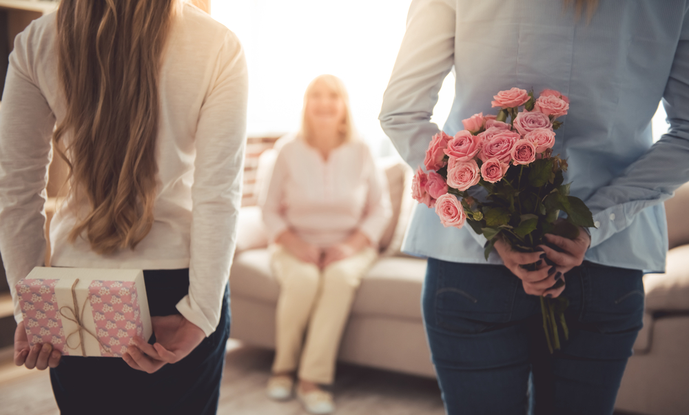 Mother and Daughter with flowers and gift