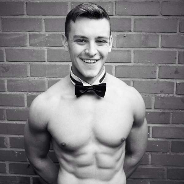 Topless butler smiling for a photo