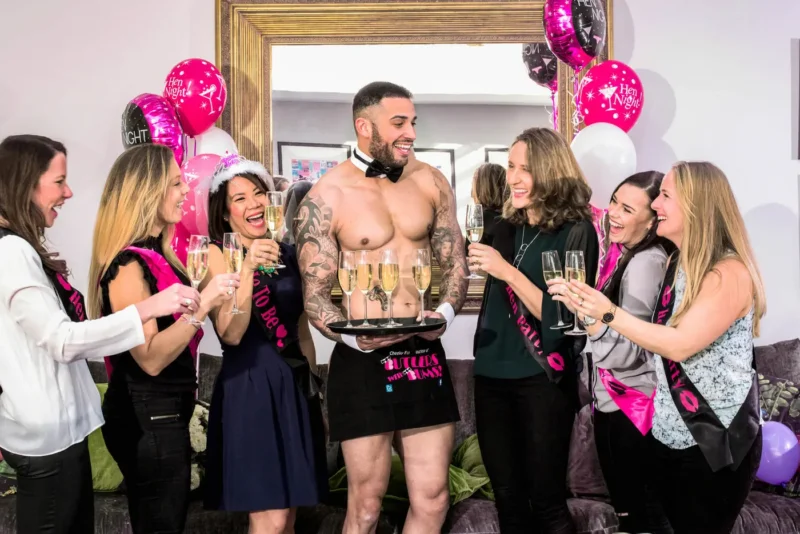 Buff butler serving drinks at a hen party