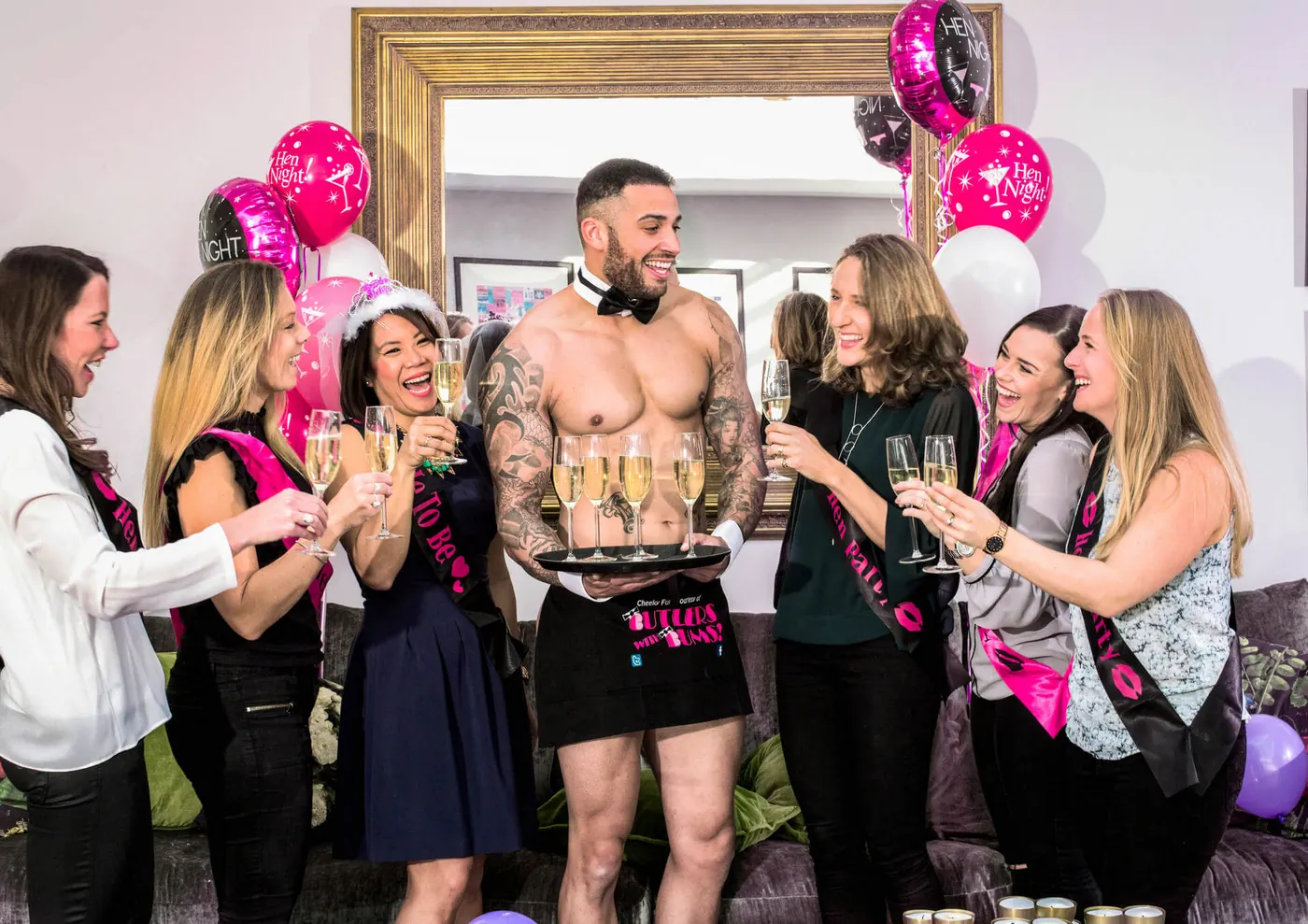 Buff butler serving drinks at a hen party